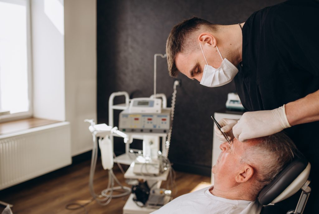 Old man visiting male doctor for plastic surgery